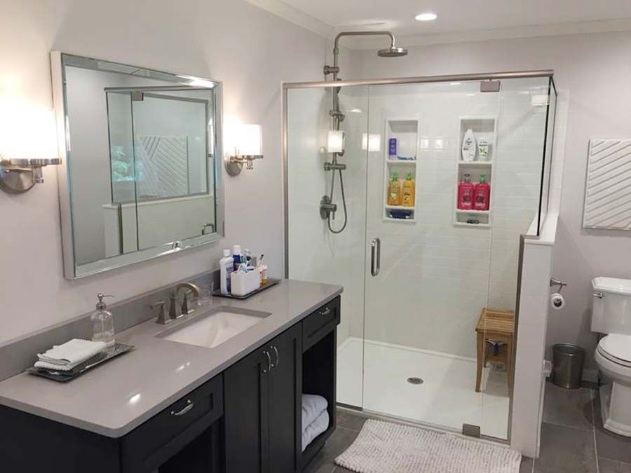 Solid surface shower pan and a framed pony wall in a University Heights remodel by The Bath Doctor