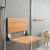 Teak fold down seat for safety in a glass block shower - Innovate Building Solutions