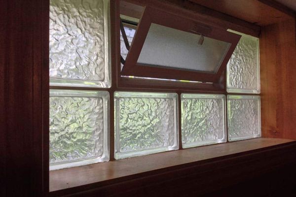 Basement glass block window with air vent inside view on a sill - Innovate Building Solutions 