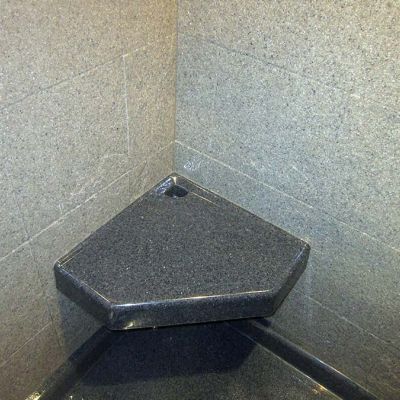 Angular corner seat in a solid surface shower - Innovate Building Solutions