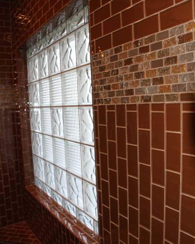 Glass block shower window in a tile shower using wave and diamond patterns - Innovate Building Solutions