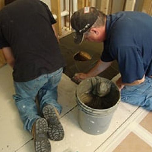 Thin set being applied before ready for tile shower base is set (note - with solid surface pans you don't need this step)