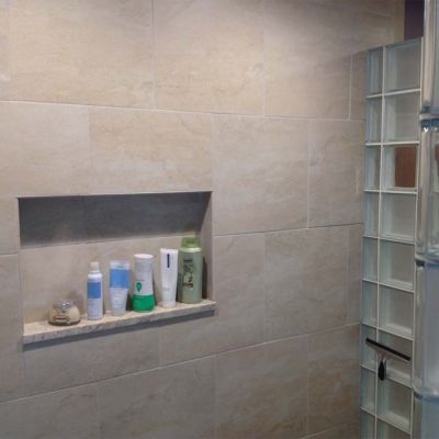 Tiled niche in a frosted glass block shower - Innovate Building Solutions