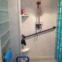 PVC marble look grout free wall panels with a blue colored glass block premade wall - Innovate Building Solutions