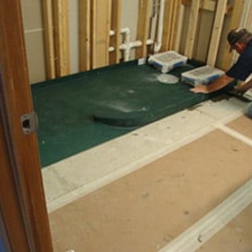 Ramped ready for tile shower pan set in place for a glass block curved wall