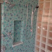 Herringbone mosaic tile niche pattern with a glass block wall - Innovate Building Solutions