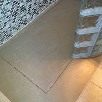Solid surface shower pan with a ramp for a glass block prefabricated wall - Innovate Building Solutions