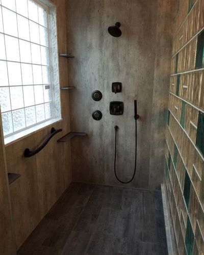 High privacy iceberg window with laminate wall panels in a glass block shower - Innovate Building Solutions
