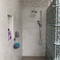 Recessed tile niche with a glass block curved wall - Innovate Building Solutions