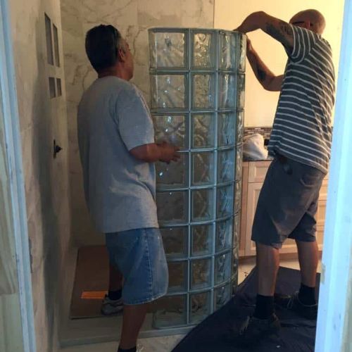 Curved glass block wall sections being installed - Innovate Building Solutions