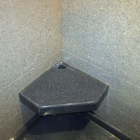 Angled durable corner seat in a solid surface shower - Innovate Building Solutions