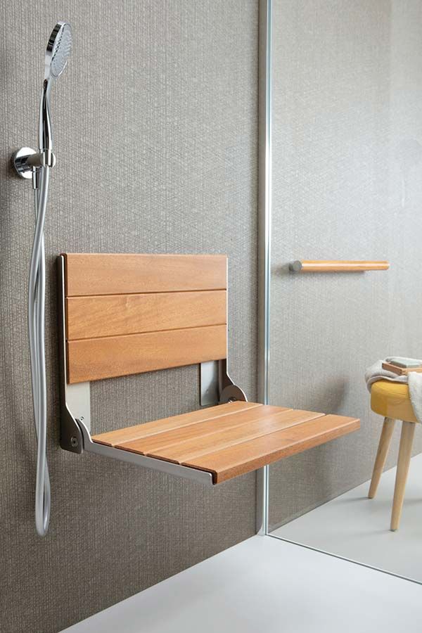 Teak fold down seat for safety in a glass block shower - Innovate Building Solutions