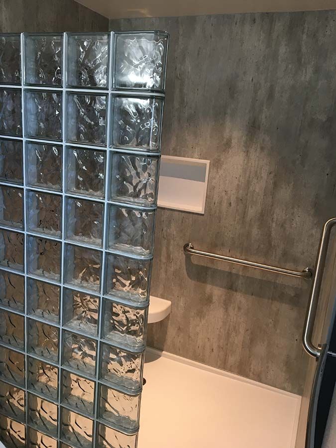 Glass block prefab shower wall wave pattern solid surface base and cracked cement laminate wall panels - Innovate Building Solutions 