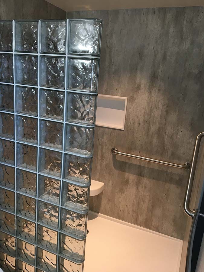 Glass block prefab shower wall wave pattern solid surface base and cracked cement laminate wall panels - Innovate Building Solutions
